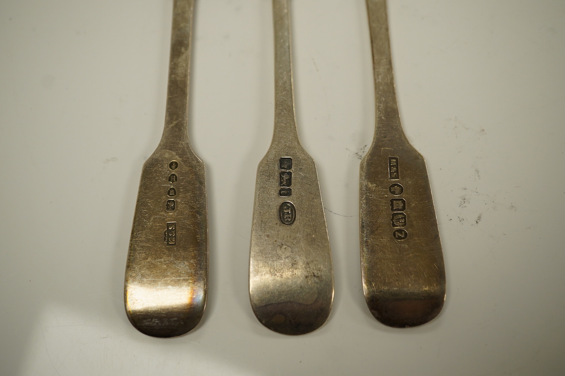 A harlequin set of eight Victorian and later silver fiddle pattern table spoons, various dates and makers. 10.8oz. Condition - fair